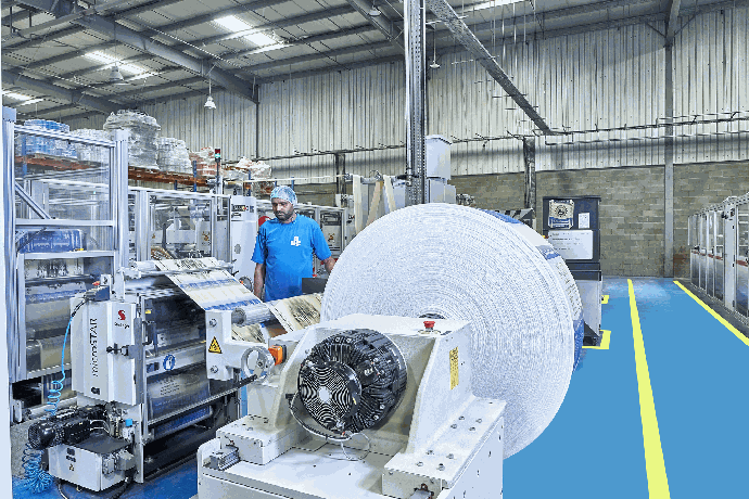 Roll of woven polypropylene fabric on a UAC production line